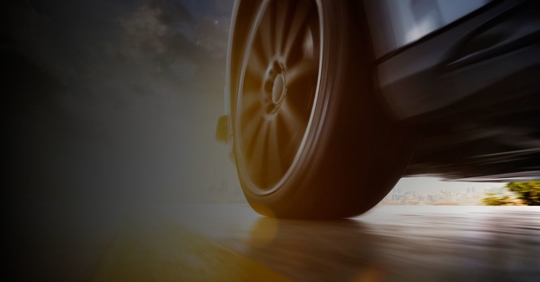Close up of the back wheel of a car on a street