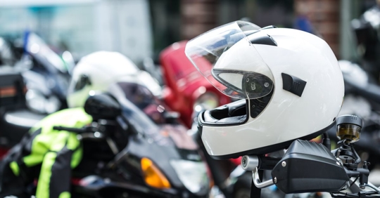 close up of a white full face motorcycle helmet sitting on top of a motorcycle