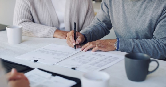 couple signing documents