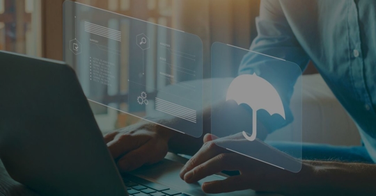 Person sitting at a laptop, with a screen appearing with an umbrella