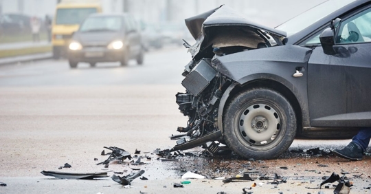side view of a black car with a crush front bumper