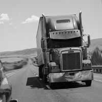 18 wheeler following a car on the freeway.