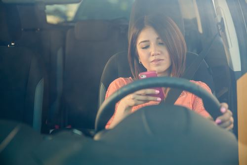 Girl texting while driving