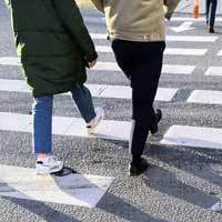 Several pedestrians crossing the street.